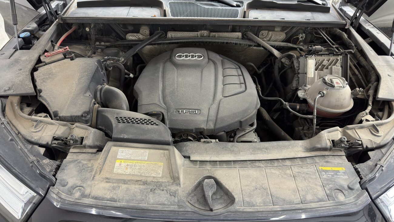 Engine bay coated in road dust before cleaning