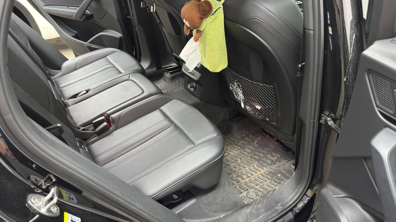 Rear seats and footwell of a family car before cleaning