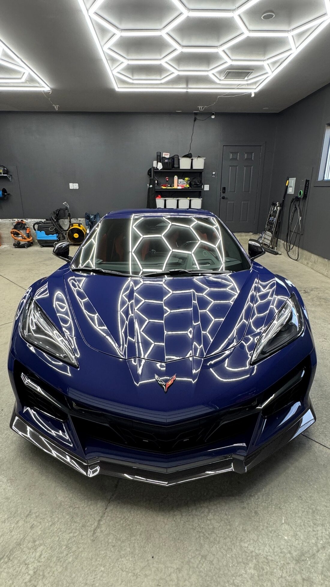 Hex studio lights reflected cleanly across a corrected Corvette hood